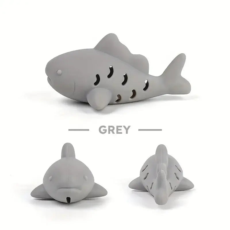 Grey silicone shark-shaped tea infuser with perforated body and smooth design for interactive treat dispensing pet toy