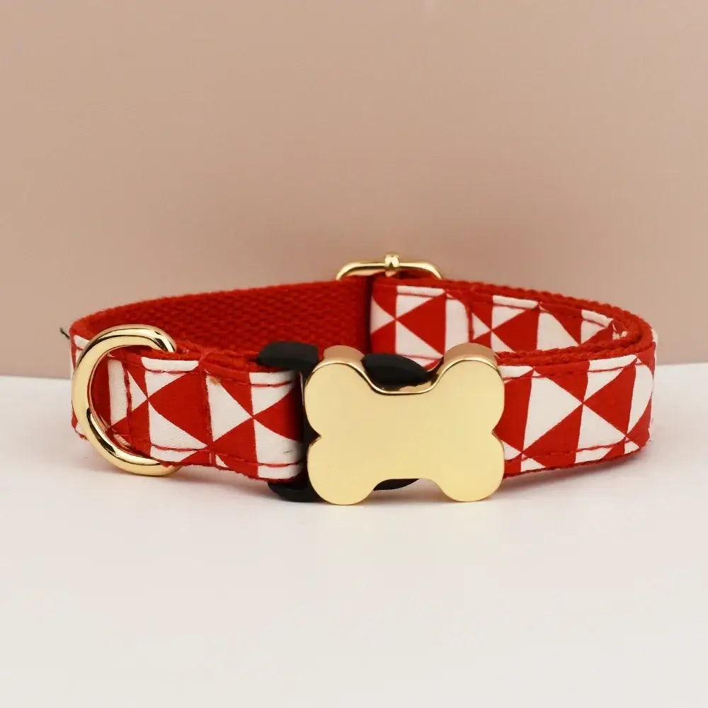 Red and white geometric dog collar with gold bone-shaped buckle premium custom engraved durable fit for pets