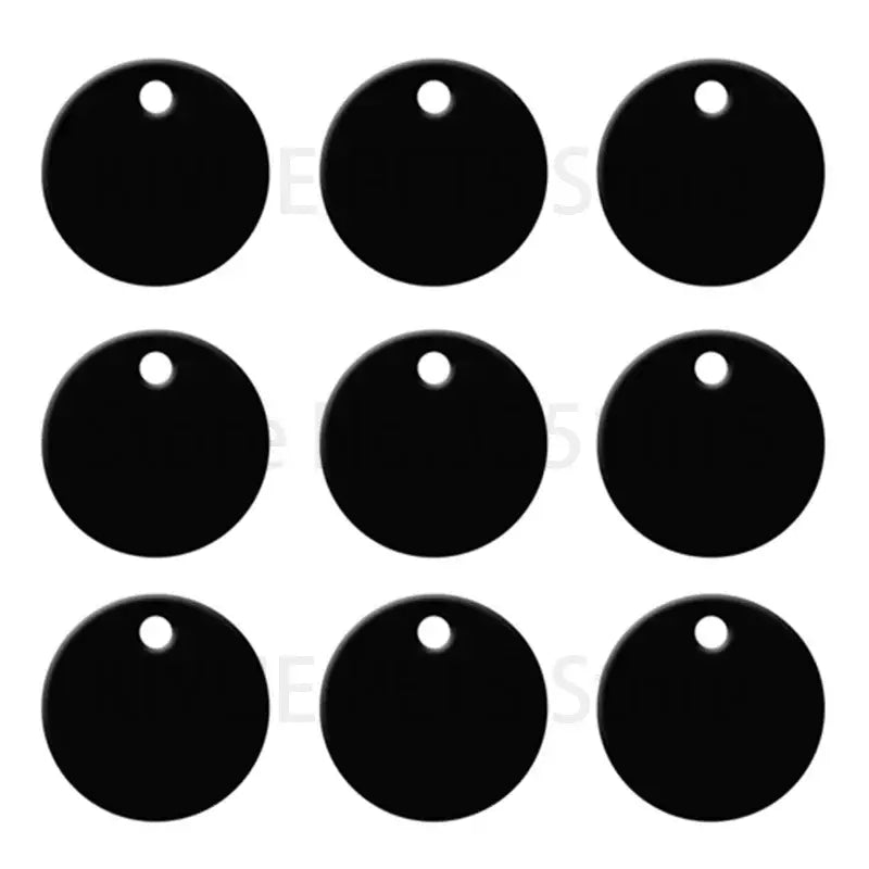 Nine black round aluminum custom engraved pet id tags with holes for attachment visible from the front side