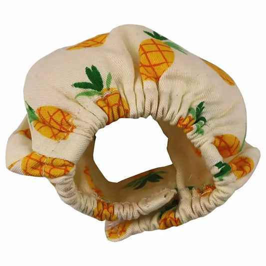 Cream-colored fabric scrunchie with yellow pineapple pattern shown with absorbent squirrel diapers for small pets