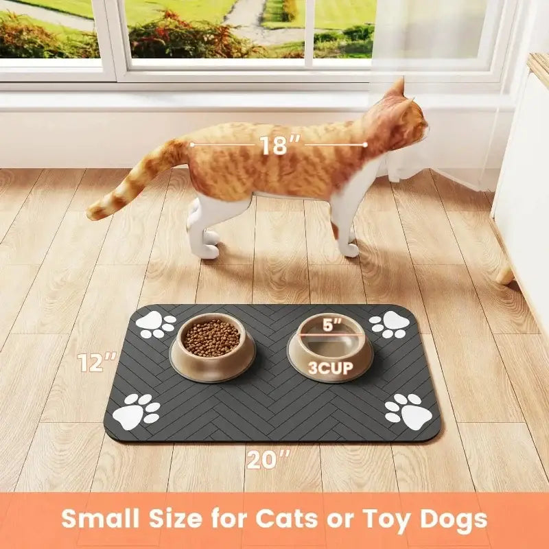 Black absorbent waterproof pet feeding mat with white paw prints non-slip surface and two bowls for cat food and water