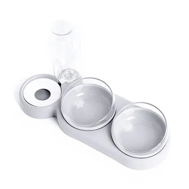 Gray plastic automatic triple bowl pet feeder with two clear glass bowls and a transparent water bottle on top