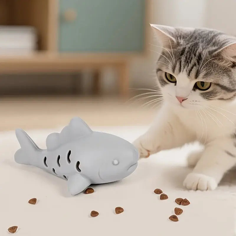 Gray silicone shark-shaped bite resistant interactive treat dispensing pet toy with perforated sides and white eye detail