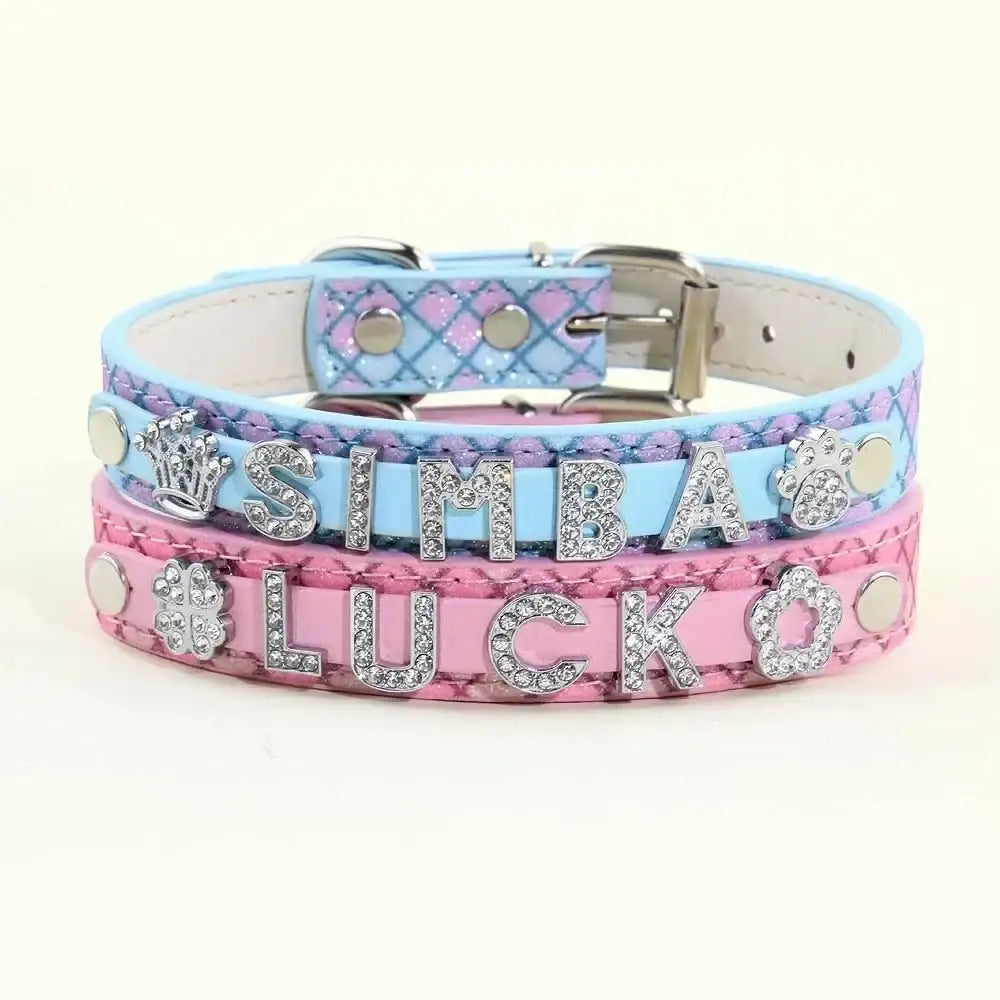 A stack of personalized bling rhinestone puppy dog collars in light blue diamond pattern and pink snakeskin texture with name charms