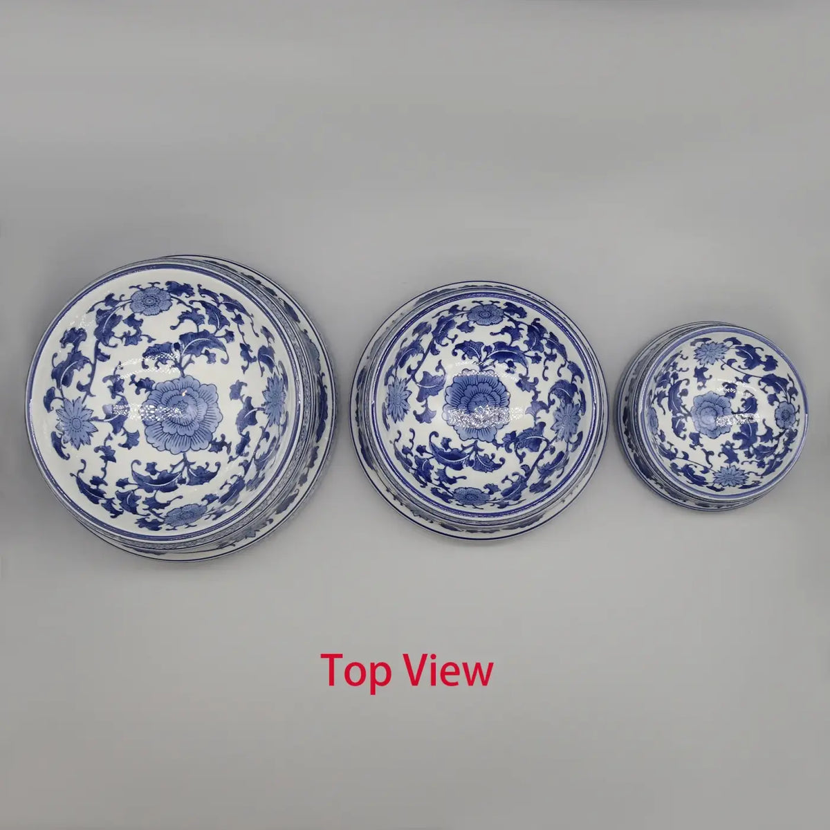Three stacked blue and white porcelain ceramic pet feeding bowls with intricate floral patterns
