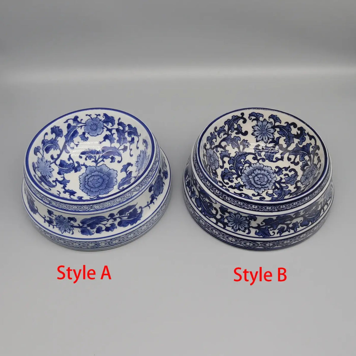 Two blue and white ceramic pet feeding bowls with intricate floral patterns and detailed borders