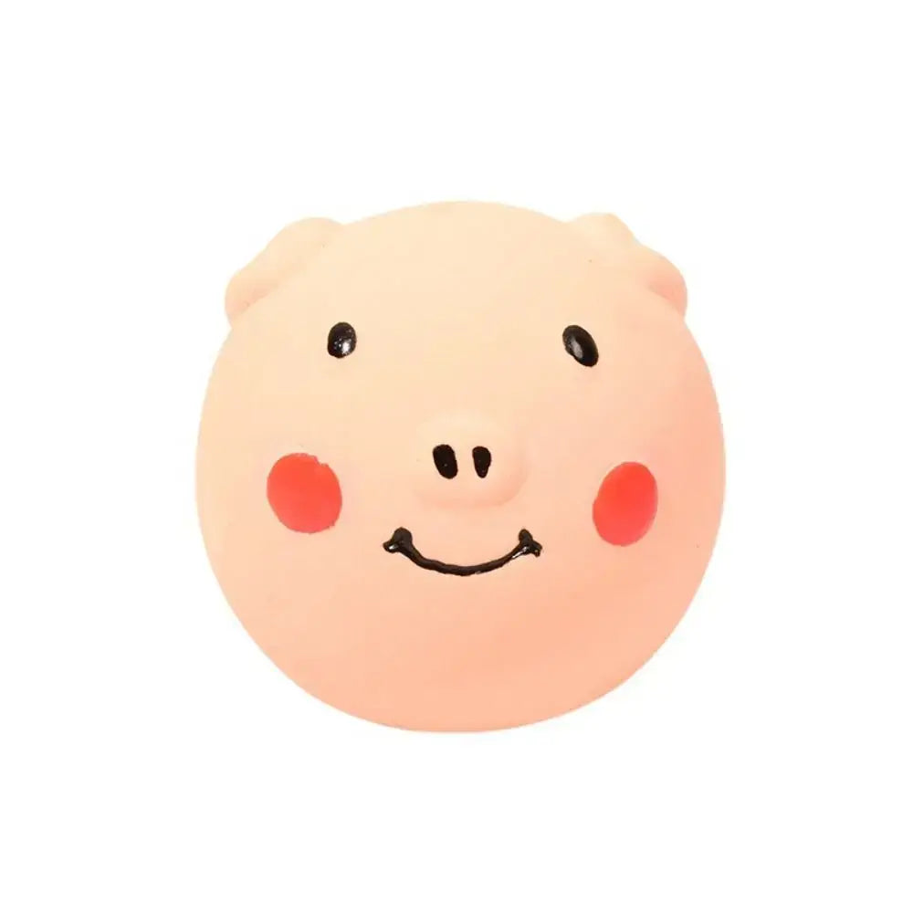 Pink pig-shaped latex squeaky dog toy stress ball with rosy cheeks and a smiling face colorful and playful design
