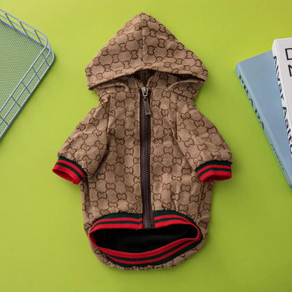 Brown gucci style hooded pet jacket with monogram pattern and red green striped cuffs and hem for schnauzer dogs