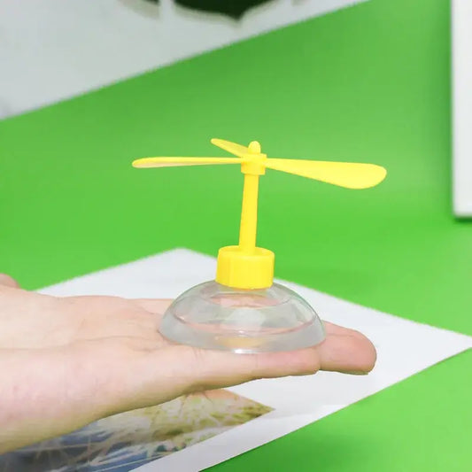 Yellow plastic toy helicopter with clear suction cup base from funny helicopter propeller pet helmet with bamboo dragonfly