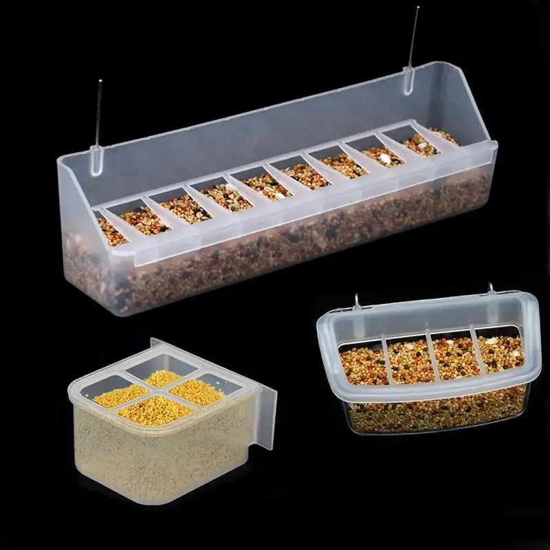 Clear plastic hanging bird and poultry feeder drinker box with multiple compartments filled with mixed seeds