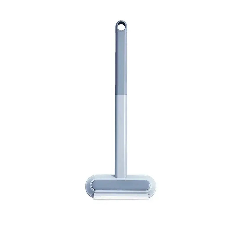 Gray plastic long handle static pet hair remover and grooming tool with a rectangular head and white rubber blade
