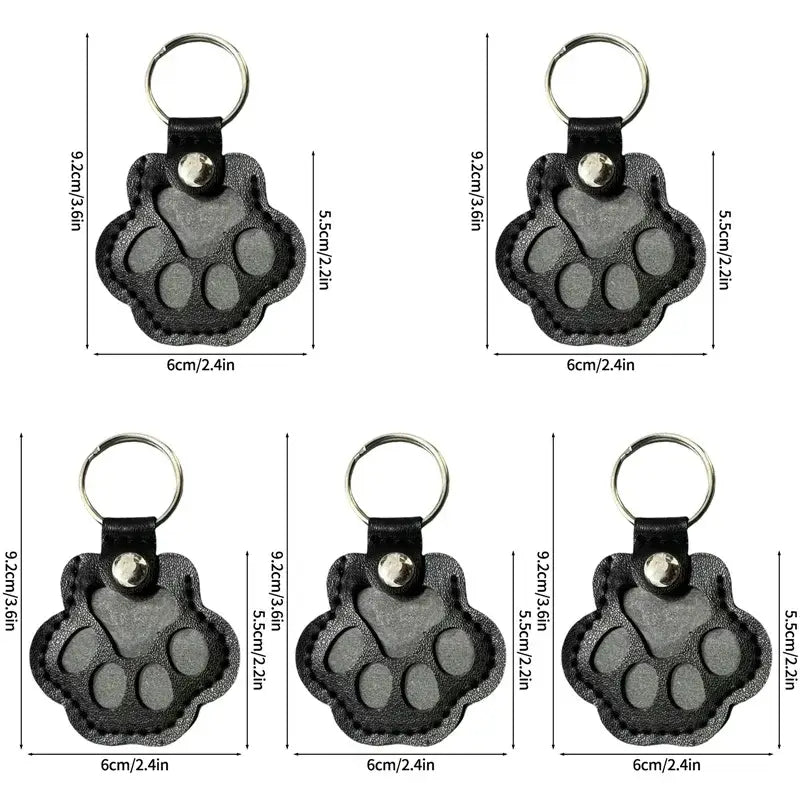 Black paw-shaped pet fur memorial keepsake keychain with textured surface and silver-toned metal ring