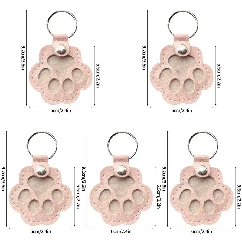 Pink leather paw print pet fur memorial keepsake keychain with stitched edges and silver metal ring for hair storage