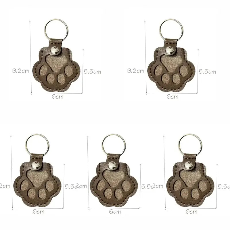 Brown leather pet fur memorial keepsake keychain with paw print stitching and metallic ring for hair storage bag