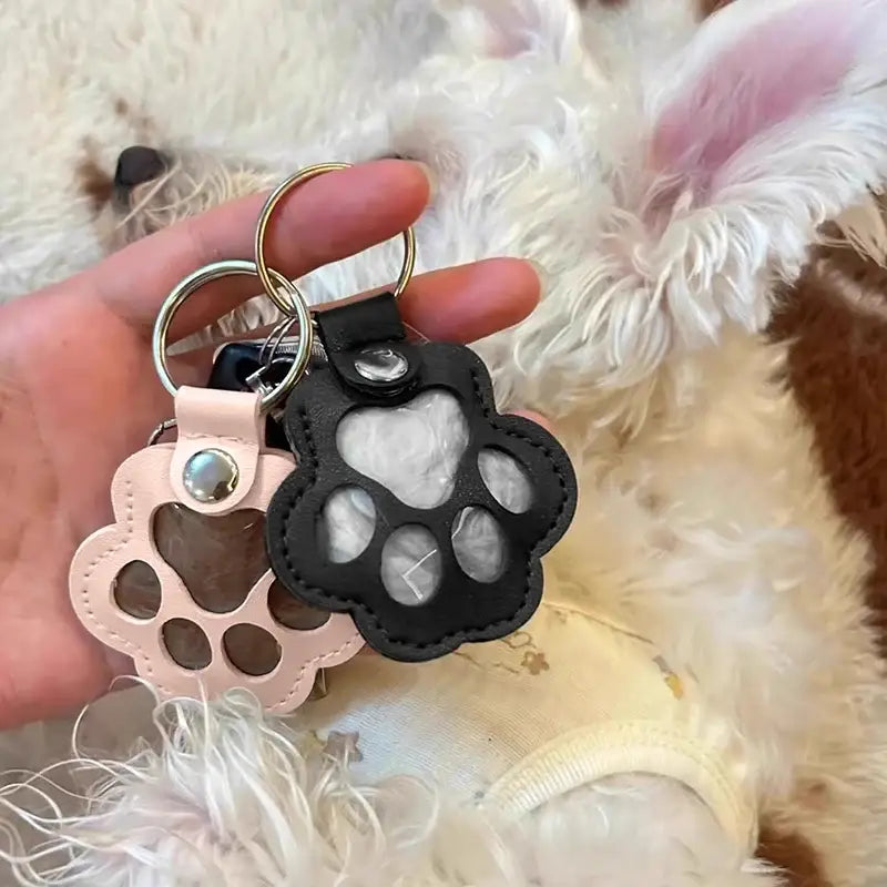 Black leather paw-shaped pet fur memorial keepsake keychain with clear window and silver-toned snap button