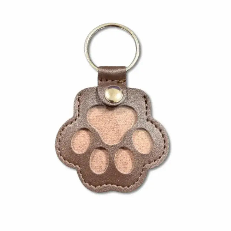 Brown leather paw print keychain with heart cutout for pet fur memorial keepsake and hair storage bag