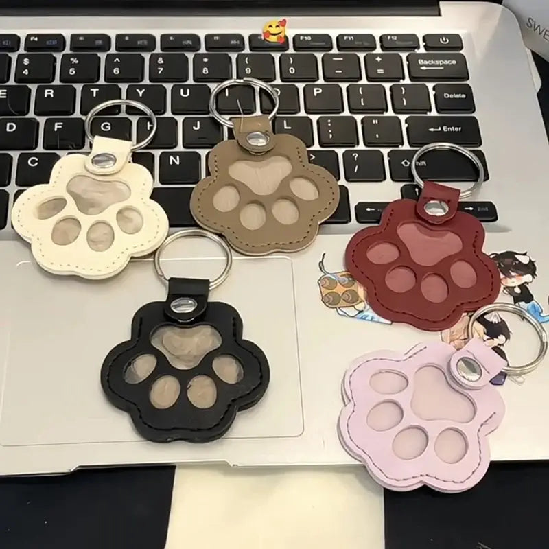 Pet fur memorial keepsake keychains in cream tan red black and pink leather with clear window inserts for hair storage