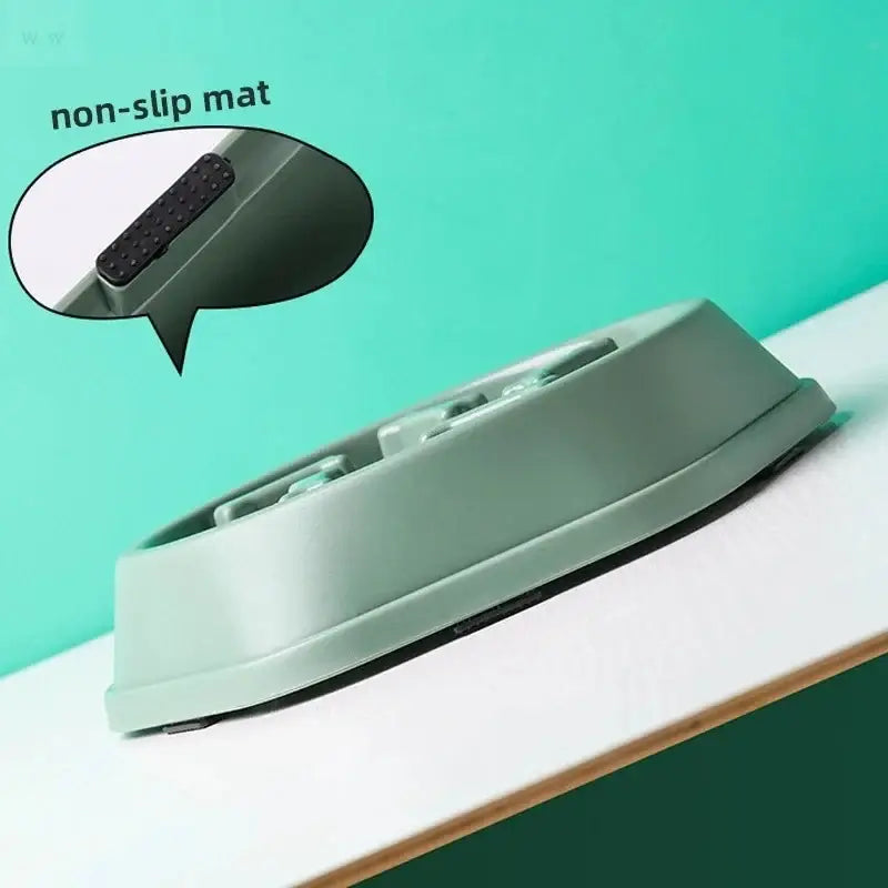 A sleek matte sage green pp plastic pet slow food bowl with non-slip base and multiple compartments for controlled feeding