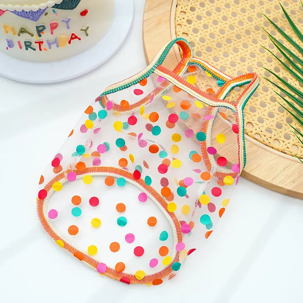 A transparent mesh dog vest with colorful orange pink yellow and teal polka dots for pet clothing supplies