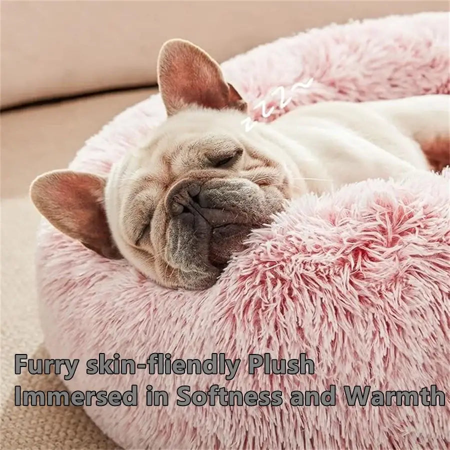 Pink plush round calming pet bed for cats and small dogs with fluffy fur like texture