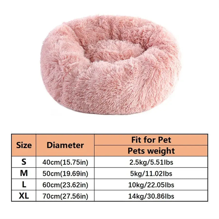 A plush round faux fur calming pet bed in soft pink with long fluffy fur for cozy pets