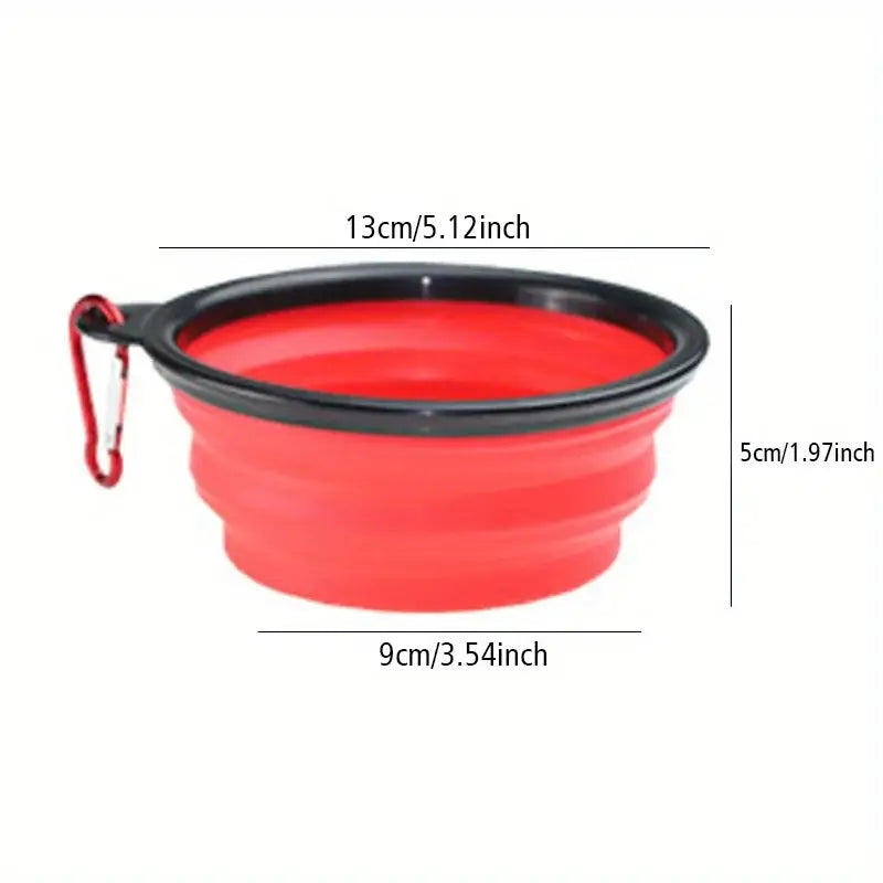 Red collapsible silicone dog travel bowl with black rim and red carabiner clip for portable pet feeding