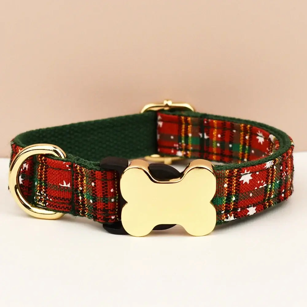 A festive red and green plaid premium custom engraved dog collar with a gold bone-shaped buckle for dogs