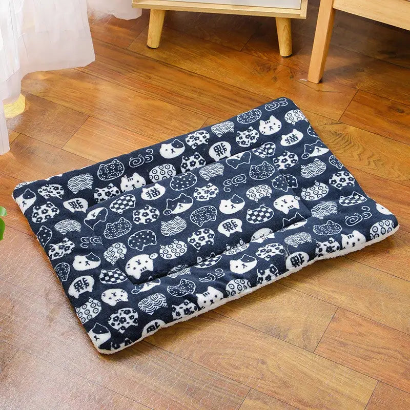 Navy blue plush pet bed with soft fleece interior and patterned design featuring a white cat for warm pet comfort