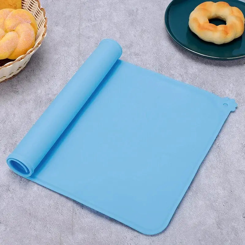 Light blue waterproof silicone pet feeding mat with rounded corners and small hole for hanging